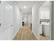 Hallway leading to laundry room with white cabinets and machines at 9645 Little Bluestem Dr, Land O Lakes, FL 34637
