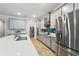 Gourmet kitchen with stainless steel appliances, quartz countertops, custom cabinetry, and a walk-in pantry at 9645 Little Bluestem Dr, Land O Lakes, FL 34637