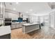 Bright, open kitchen with island seating, stainless appliances, and a separate dining area at 9645 Little Bluestem Dr, Land O Lakes, FL 34637