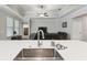 Kitchen sink featuring quartz countertops, stainless steel faucet, and stainless steel sink at 9645 Little Bluestem Dr, Land O Lakes, FL 34637