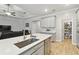 Kitchen island with stainless steel sink, quartz countertops, and plenty of storage space at 9645 Little Bluestem Dr, Land O Lakes, FL 34637