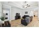 Inviting living room showcasing a tray ceiling, wood-look floors, and modern furniture at 9645 Little Bluestem Dr, Land O Lakes, FL 34637