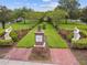 Lush Magnolia Park walkway featuring manicured landscaping and brick-paved pathway at 9645 Little Bluestem Dr, Land O Lakes, FL 34637