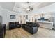 Open-concept layout connecting the living room and kitchen with cohesive flooring and design elements at 9645 Little Bluestem Dr, Land O Lakes, FL 34637