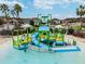The splash pad features water bucket drops, slides, and kid-friendly features with shady areas at 9645 Little Bluestem Dr, Land O Lakes, FL 34637