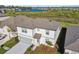 Aerial view of a house with lush landscaping and a nearby pond, highlighting the property's serene setting at 11022 Moonsail Dr, Parrish, FL 34219