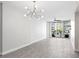 Bright living room with gray flooring, modern lighting, and balcony access at 1120 E Kennedy Blvd # 1126, Tampa, FL 33602