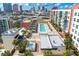 Overhead shot of a community rooftop swimming pool with lounge chairs and umbrellas at 1120 E Kennedy Blvd # 1126, Tampa, FL 33602