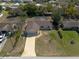 Aerial view highlighting the single story home and driveaway and front yard in an established neighborhood at 11304 Sedgefield Ave, Spring Hill, FL 34608