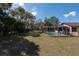 View of the screened-in pool and spacious backyard, perfect for outdoor entertaining and relaxation at 11304 Sedgefield Ave, Spring Hill, FL 34608
