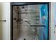 Updated shower with tiled walls, glass door, and modern fixtures, offering a spa-like experience at 11304 Sedgefield Ave, Spring Hill, FL 34608