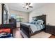 Relaxing main bedroom features dark wood floors, a large window, and comfortable seating at 15664 Starling Water Dr, Lithia, FL 33547