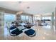 Bright dining area features water view, modern chandelier, and stylish glass table with seating for eight at 173 Marina Del Rey Ct, Clearwater Beach, FL 33767