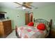 Charming bedroom featuring a ceiling fan, a quaint quilt, and an antique dresser with shelving at 18405 Keystone Grove Blvd, Odessa, FL 33556