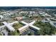 Aerial view of residential community featuring tennis courts and community pool at 2041 Australia W Way # 35, Clearwater, FL 33763