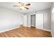 Spacious bedroom with wood-look flooring and a ceiling fan at 2041 Australia W Way # 35, Clearwater, FL 33763