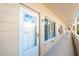 Exterior front door, white door with glass panes, and windows with blinds at 2041 Australia W Way # 35, Clearwater, FL 33763