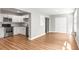 Bright kitchen features white cabinets, stainless steel appliances, and wood-look flooring open to the living area at 2041 Australia W Way # 35, Clearwater, FL 33763