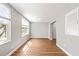 Bright living room with wood-look floors, neutral walls, and sun-filled windows at 2041 Australia W Way # 35, Clearwater, FL 33763