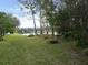 A scenic backyard includes a pond view, lush green grass, and mature trees at 3147 Sunwatch Dr, Wesley Chapel, FL 33544
