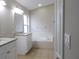 Large bathroom with dual vanities with granite countertops, bathtub, and tile floors at 3147 Sunwatch Dr, Wesley Chapel, FL 33544