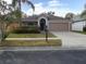 Charming single-story home featuring a two-car garage and well-maintained landscaping at 3147 Sunwatch Dr, Wesley Chapel, FL 33544