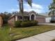 View of the front of the residence and driveway showing the landscaping at 3147 Sunwatch Dr, Wesley Chapel, FL 33544