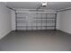 Spacious two-car garage with clean, painted walls and sealed concrete floor, ready for your vehicles at 3147 Sunwatch Dr, Wesley Chapel, FL 33544