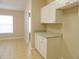 Bright kitchen area featuring white cabinets, granite countertops, and tile flooring at 3147 Sunwatch Dr, Wesley Chapel, FL 33544