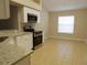Modern kitchen featuring stainless steel appliances, granite counters and tile floors at 3147 Sunwatch Dr, Wesley Chapel, FL 33544