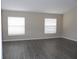 Spacious living room featuring hard surface flooring, neutral walls, and large windows at 3147 Sunwatch Dr, Wesley Chapel, FL 33544