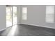 Living room featuring hard surface floors, sliding glass doors, and a window at 3147 Sunwatch Dr, Wesley Chapel, FL 33544