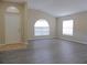 Spacious living room featuring new floors and a large window for natural light at 3147 Sunwatch Dr, Wesley Chapel, FL 33544