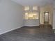 Bright open living area with view to the kitchen and front entry at 3147 Sunwatch Dr, Wesley Chapel, FL 33544