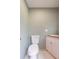 Simple powder room with a toilet, sink, and light-colored walls, creating a clean and functional space at 32608 Knollwood Ln, Wesley Chapel, FL 33545