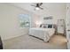 Light filled bedroom features a ceiling fan, large window and plush carpet at 3313 Pleasant Willow Ct, Brandon, FL 33511