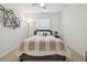 Bedroom with large window, ceiling fan and decorative wall art at 3313 Pleasant Willow Ct, Brandon, FL 33511