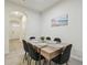 Dining area featuring a modern table set for six, next to the kitchen at 3313 Pleasant Willow Ct, Brandon, FL 33511