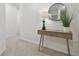 Hallway with table and lamp and round mirror at 3313 Pleasant Willow Ct, Brandon, FL 33511