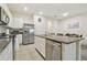 Bright kitchen with granite countertops and stainless steel appliances and adjacent dining area at 3313 Pleasant Willow Ct, Brandon, FL 33511