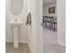This is a white powder room with pedestal sink and stylish mirror at 3313 Pleasant Willow Ct, Brandon, FL 33511