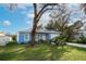 Attractive blue single-Gathering house with a landscaped front yard and attached one-car garage at 509 11Th Nw Ave, Largo, FL 33770