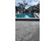 Exterior view of a pool with blue lounge chairs and surrounding landscaping at 5162 Puritan Cir # 5162, Tampa, FL 33617