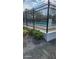 Exterior view of a gated pool with clear water and surrounding landscaping at 5162 Puritan Cir # 5162, Tampa, FL 33617