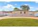 Tan single-story home featuring a brick facade and a carport with a concrete driveway and a green lawn at 6516 Saline St, Tampa, FL 33634