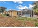 View of backyard with an enclosed in-ground pool, and home's yellow exterior at 6537 8Th N Ave, St Petersburg, FL 33710