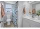 Well-lit bathroom featuring a white toilet, vanity with sink, and a fun fish-themed shower curtain at 6537 8Th N Ave, St Petersburg, FL 33710