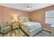Cozy bedroom with a light colored bed, ceiling fan, and ample natural light at 6537 8Th N Ave, St Petersburg, FL 33710