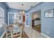 Inviting dining room featuring a charming table set for four, light blue walls, and adjacent kitchen at 6537 8Th N Ave, St Petersburg, FL 33710