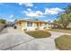 Charming one-story home with a spacious driveway, well-manicured lawn, and screened-in porch at 6537 8Th N Ave, St Petersburg, FL 33710